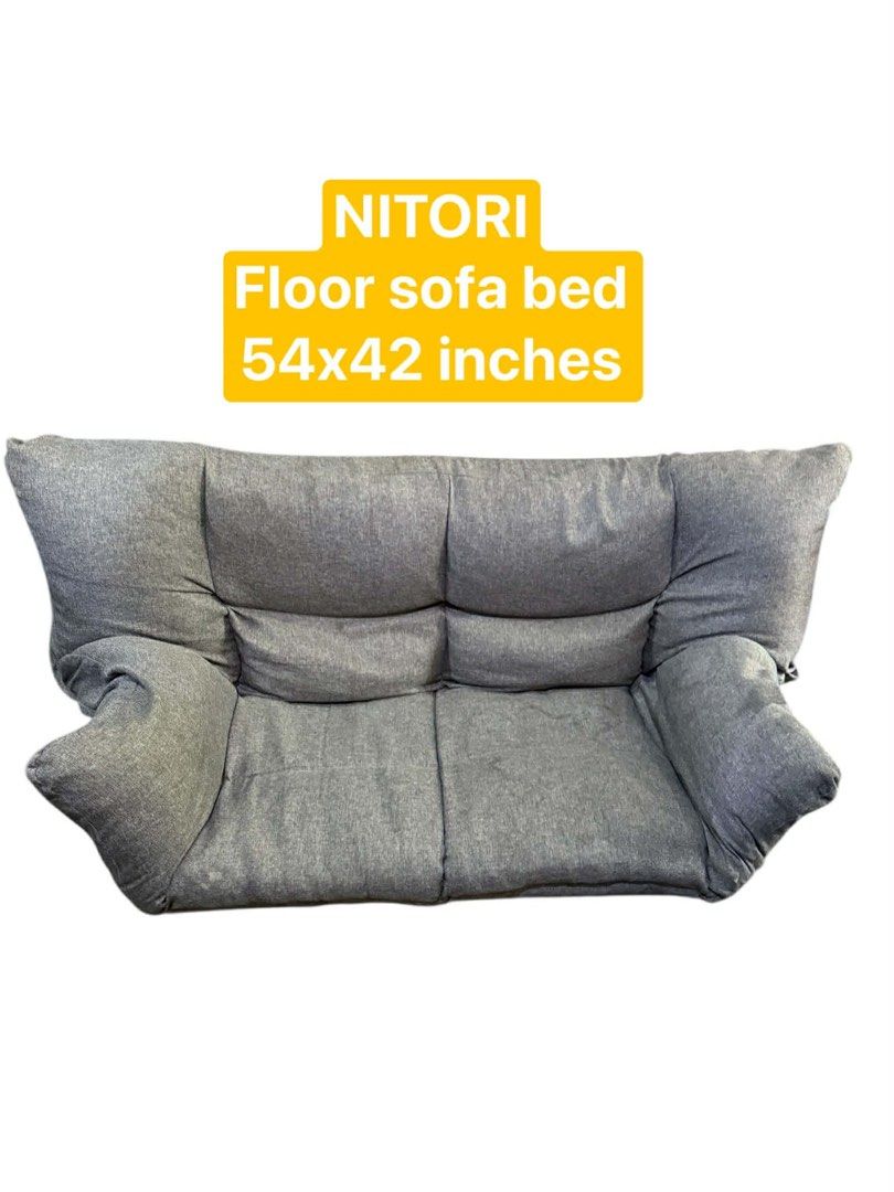 NITORI Floor Sofa Bed 54x42 inches (Category: Sofas) located in Quezon City. Submitted by mikesiawingco (Listing ID 1415758007, Image 1). Description: - NITORI floor sofa bed - Color: Gray - Folds flat for easy storage - Dimensions: 54x42 inches - Features a cushioned backrest - Includes armrests - Made with textured fabric.
