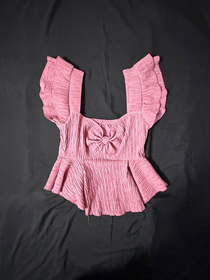 Pink Textured Top with Bow Detail (Category: Blouses) located in Makati City. Submitted by prelovedump19 (Listing ID 1415789312, Image 1). Description: - Pink top - Textured fabric - Square neckline - Bow detail at bust - Peplum hem - Short, ruffled sleeves - Dress up or down style.