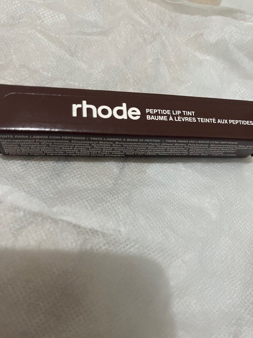 Rhode Peptide Lip Tint (Category: Makeup) located in Davao. Submitted by honeykikai (Listing ID 1415748856, Image 1). Description: - New Rhode Peptide Lip Tint - Contains peptides - Dark brown packaging - Unused.