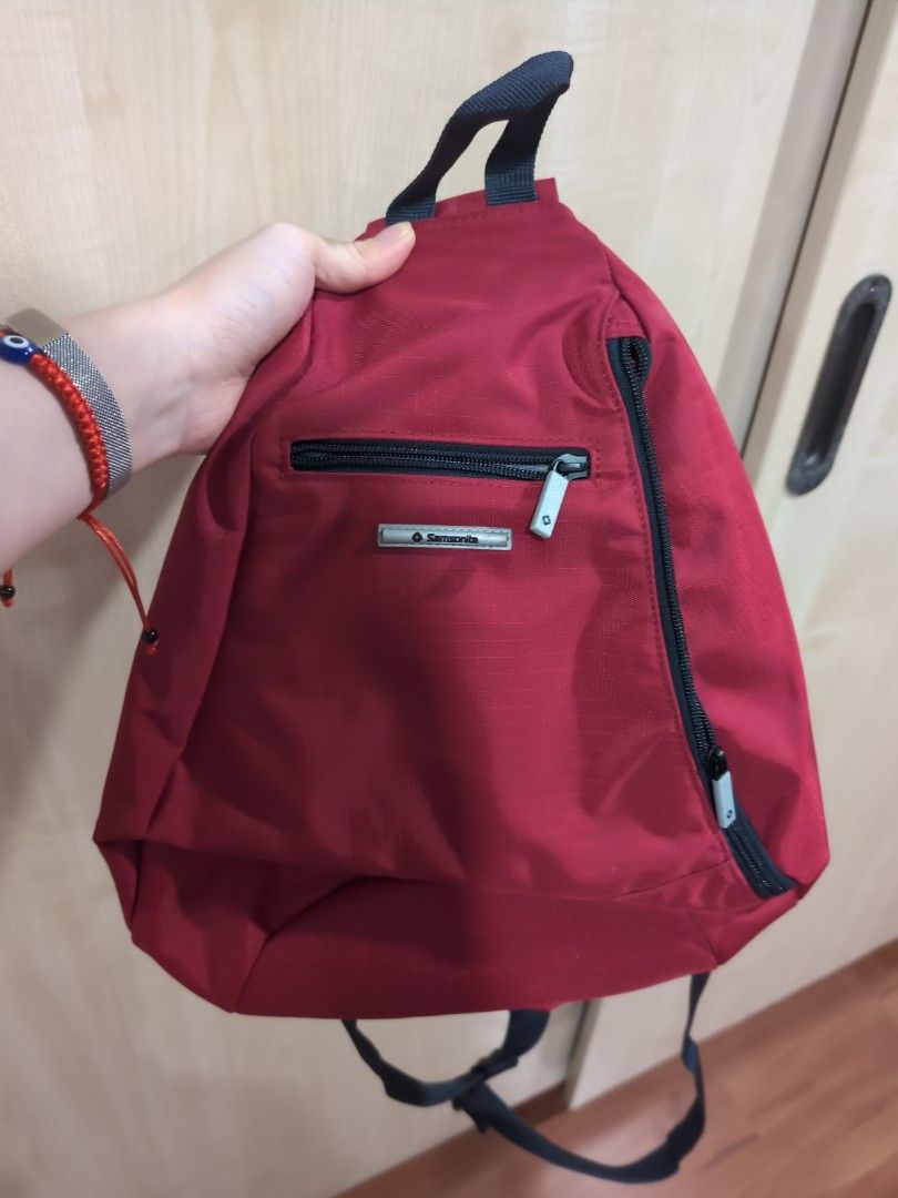 Samsonite Red Sling Backpack (Category: Backpacks) located in Manila. Submitted by liannemelody (Listing ID 1415773642, Image 1). Description: - Samsonite red sling backpack - Single strap design - Main compartment with zipper closure - Additional front pocket - Padded back for comfort - Adjustable strap - Durable, water-resistant material.