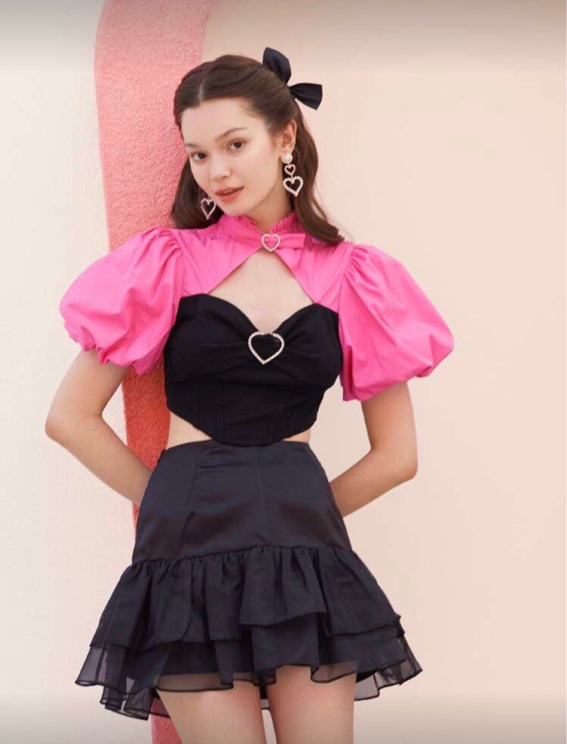 Shein Pink Puff Sleeve Top (Category: Blouses) located in Pasig City. Submitted by martinasummer13 (Listing ID 1415658523, Image 1). Description: - Shein top - Pink puff sleeves - Black corset-style bodice - Heart-shaped buckle detail - High collar - Satin-like fabric - Unique and stylish.