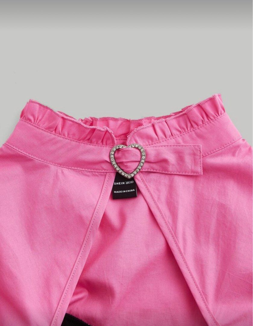 Shein Pink Puff Sleeve Top (Category: Blouses) located in Pasig City. Submitted by martinasummer13 (Listing ID 1415658523, Image 3). Description: - Shein top - Pink puff sleeves - Black corset-style bodice - Heart-shaped buckle detail - High collar - Satin-like fabric - Unique and stylish.