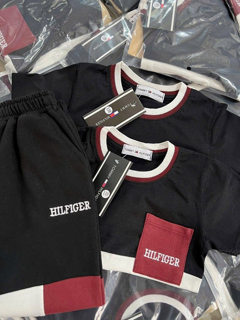 Tommy Hilfiger Kids Terno Set (Category: Babies & Kids Fashion) located in Manila. Submitted by aleicollection2 (Listing ID 1415814169, Image 3). Description: Stylish two-piece set for kids. Features a black and white top with a red pocket, paired with matching red and white pants. The top has a round neck with a red trim. The set is packaged in clear plastic. Perfect for casual wear. Available sizes 👇🏻 18-24m✅ 2-3y✅ 3-4y✅ 4-5y✅ 6-7y❌ Made in V