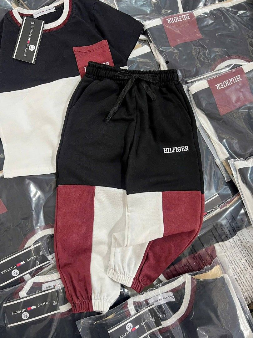 Tommy Hilfiger Kids Terno Set (Category: Babies & Kids Fashion) located in Manila. Submitted by aleicollection2 (Listing ID 1415814169, Image 2). Description: Stylish two-piece set for kids. Features a black and white top with a red pocket, paired with matching red and white pants. The top has a round neck with a red trim. The set is packaged in clear plastic. Perfect for casual wear. Available sizes 👇🏻 18-24m✅ 2-3y✅ 3-4y✅ 4-5y✅ 6-7y❌ Made in V