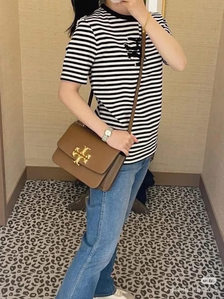 Tory Burch Kira Chevron Shoulder Bag (Category: Luxury Bags & Wallets) located in Manila. Submitted by santosrich_419 (Listing ID 1415783355, Image 3). Description: Tory Burch Kira Chevron shoulder bag features a gold-tone logo and a detachable shoulder strap. It has a flap closure and a spacious interior. The bag is available in multiple colors, including black, brown, and cream. The dimensions of the black bag are 24x16cm. It's a stylish and ve