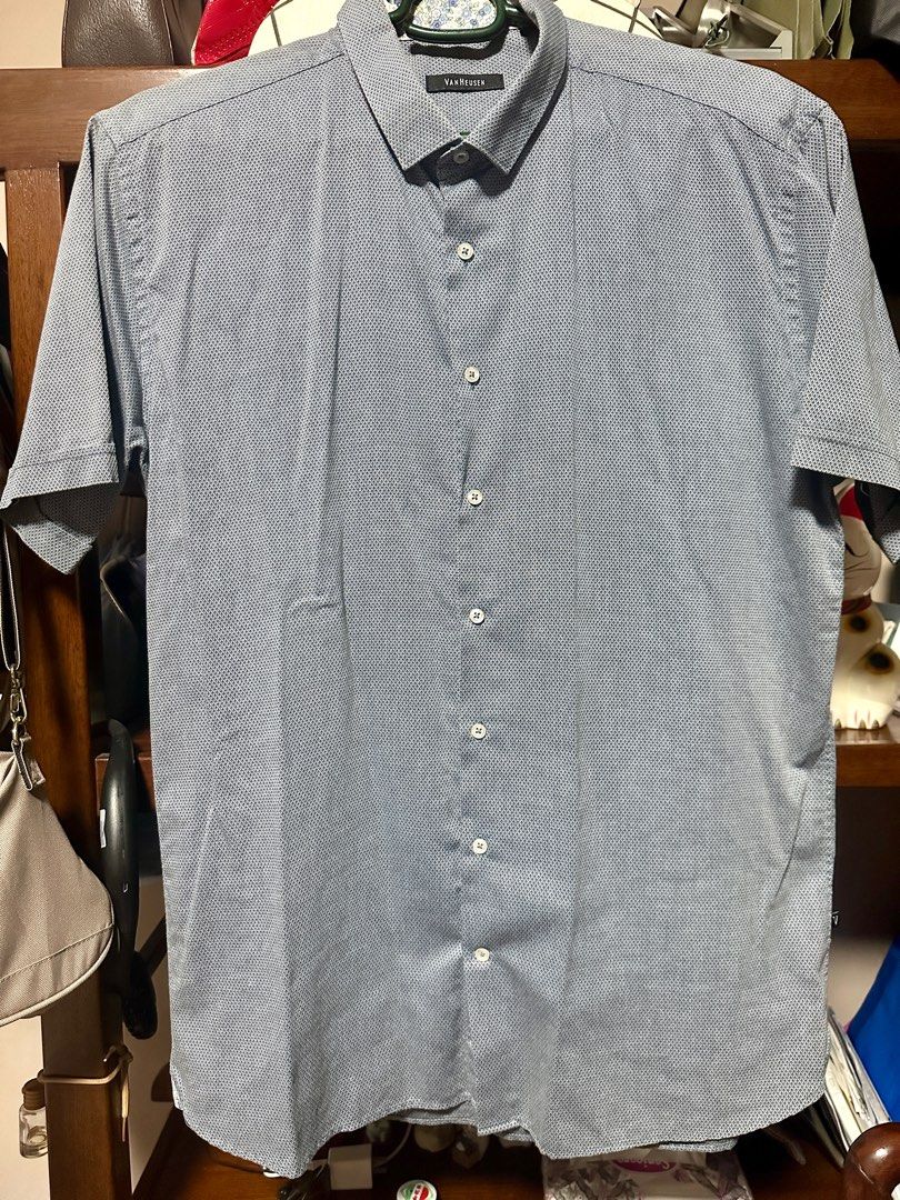 Van Heusen Short Sleeve Shirt (Category: Tshirts & Polo Shirts ) located in Quezon City. Submitted by declutter_incorporated (Listing ID 1415792424, Image 1). Description: - Van Heusen short sleeve shirt - Subtle textured pattern - Polycotton blend - Button-down front - Classic collar - Small logo on left side - Made in Thailand - Care: Machine wash cold, gentle cycle; non-chlorine bleach (if needed); do not tumble dry; cool iron.