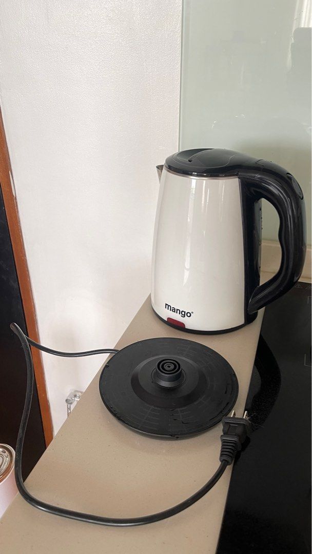 White Electric Kettle (Category: Kettles & Airpots) located in Pasig City. Submitted by eunicemae (Listing ID 1415641583, Image 2). Description: - No issues. Works perfectly - White and black Mango electric kettle - Detachable base - Black handle - Clean interior - Red power indicator light - Removable lid for easy filling and cleaning - Includes power cord.