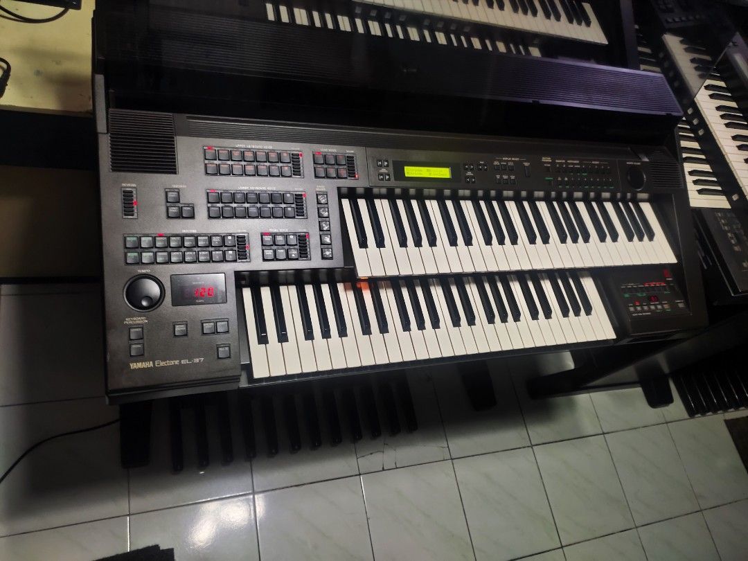 Yamaha Electone EL-37 Electronic Organ (Category: Musical Instruments) located in Quezon City. Submitted by gwace1717 (Listing ID 1415821278, Image 3). Description: - Yamaha Electone EL-37 electronic organ - Features multiple keys and control panels - Includes a display screen - Dark gray finish - In good working condition - Ideal for musicians and music learners.