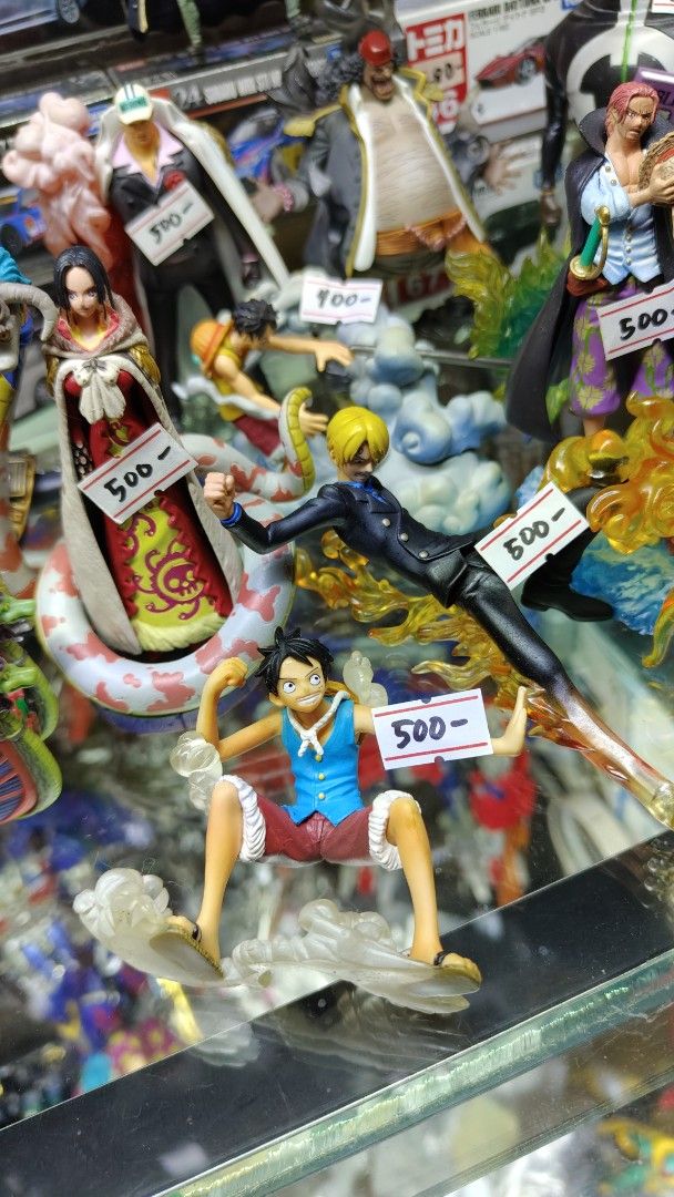 Assorted Tomica Transformers One Piece Luffy, Sanji, Boa Hancock Figures (Category: Figurines & Statues) located in Manila. Submitted by rossinicalabig (Listing ID 1415934607, Image 1). Description: 200-2000 Pesos each. Assorted Japan Surplus Toys. Collectible One Piece figures featuring Luffy, Sanji, and Boa Hancock. Each figure is detailed and comes with a base. Perfect for fans of the anime series. Prices are indicated on the figures. Great fo