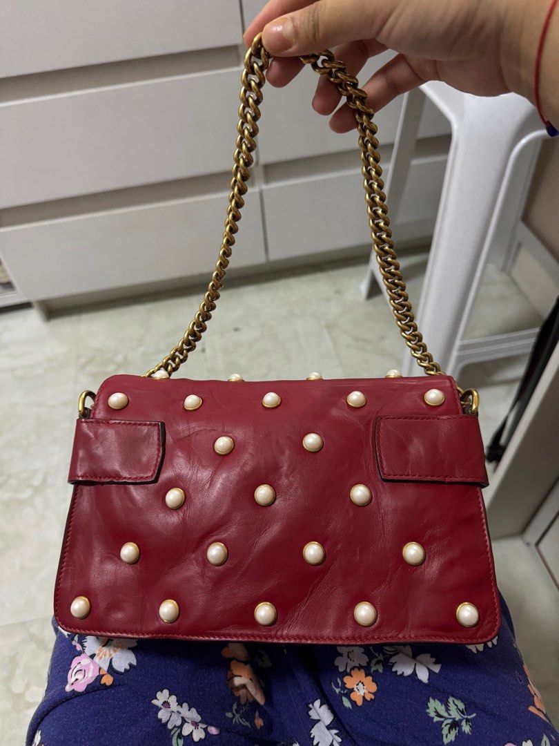 AUTHENTIC Gucci Broadway Chain Shoulder Handbag (Category: Luxury Bags & Wallets) located in Quezon City. Submitted by onestock2024 (Listing ID 1415973007, Image 2). Description: Authentic Gucci Broadway Chain Shoulder Handbag in red leather. Features a bee embellishment with pearls and a chain strap. The bag has pearl studs on the front and back. Includes a dust bag. The interior has a leather tag with the Gucci logo. 💳Mode of Payment: Gcash, B