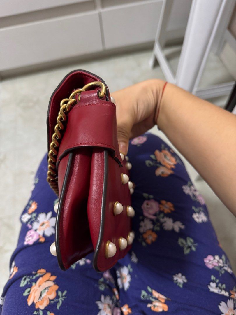 AUTHENTIC Gucci Broadway Chain Shoulder Handbag (Category: Luxury Bags & Wallets) located in Quezon City. Submitted by onestock2024 (Listing ID 1415973007, Image 3). Description: Authentic Gucci Broadway Chain Shoulder Handbag in red leather. Features a bee embellishment with pearls and a chain strap. The bag has pearl studs on the front and back. Includes a dust bag. The interior has a leather tag with the Gucci logo. 💳Mode of Payment: Gcash, B