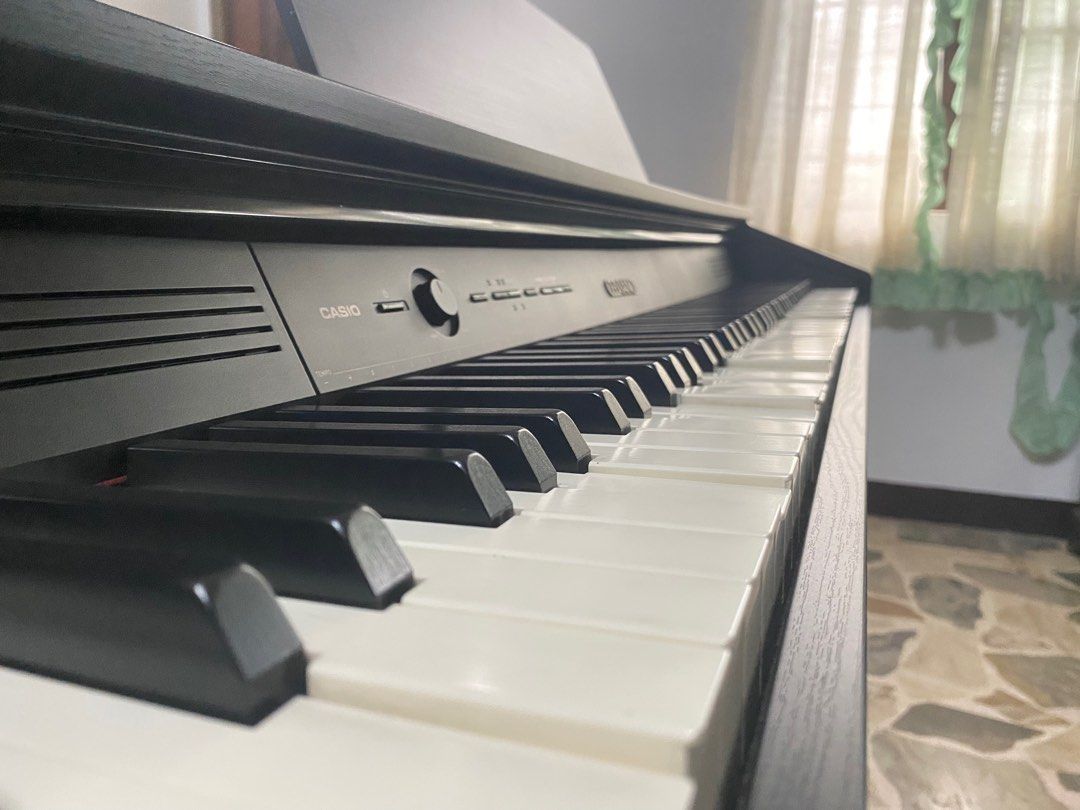 Casio Celviano AP-250 Digital Piano (Category: Musical Instruments) located in Quezon City. Submitted by chazzwazzer (Listing ID 1415844284, Image 3). Description: NEGOTIABLE PICKUP ONLY - Casio Celviano digital piano - Includes bench and music stand - Full keyboard with white and black keys - Black finish - Casio Celviano logo visible -Fully Weighted keys HONEST ISSUES -Has sunken keys -Doesn’t power on anymore.