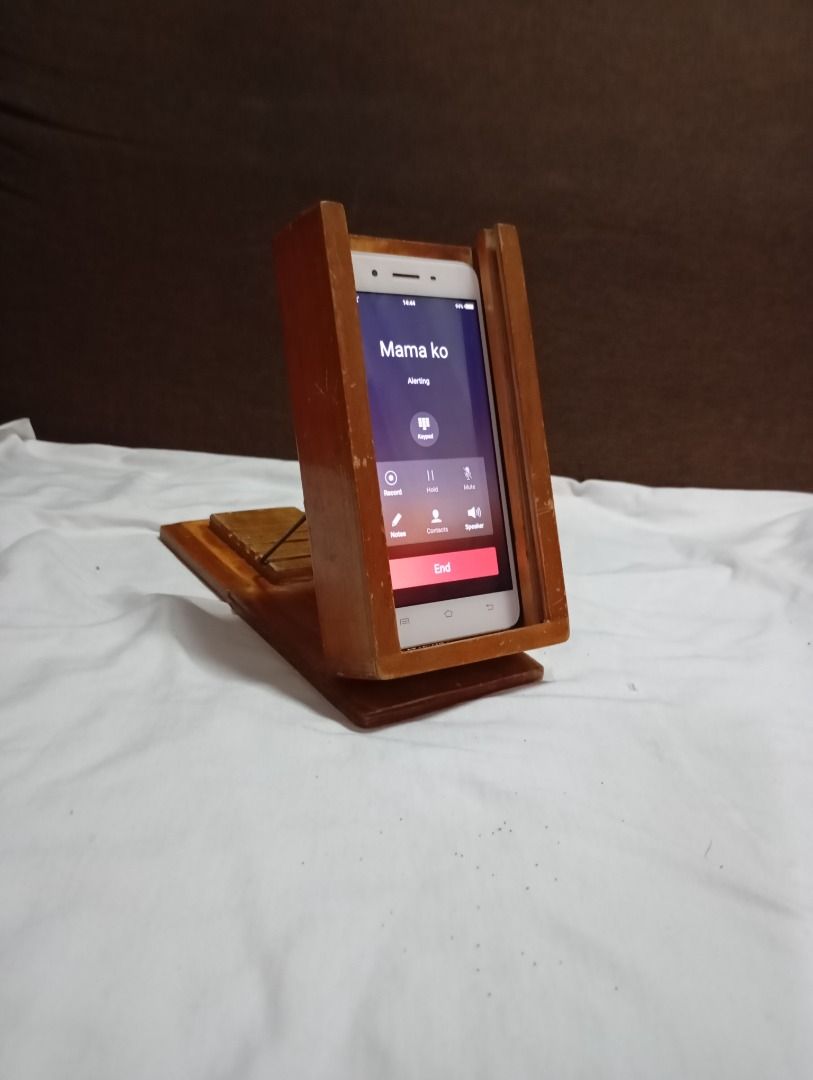 Cellphone stand (Category: Mounts & Holders) located in Quezon City. Submitted by obemistic27 (Listing ID 1415900817, Image 2). Description: This was created by my indigenous carpenter father, I could say this is his invention, I hope my future client would enjoy this. Made of wood and experience : ).