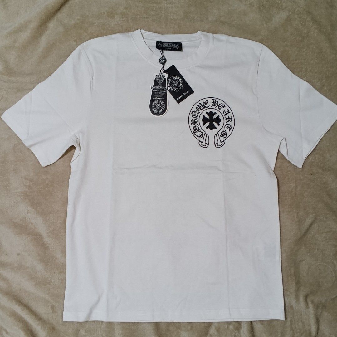 Chrome Hearts | authentic bnew overrunsss (Category: Tshirts & Polo Shirts ) located in Bulacan. Submitted by retroflair.444 (Listing ID 1415934121, Image 2). Description: - Brand new Chrome Hearts T-shirt - Size: Medium - Made in USA - Features a front logo and a design on the back - Classic crew neck and short sleeves - With tags attached.