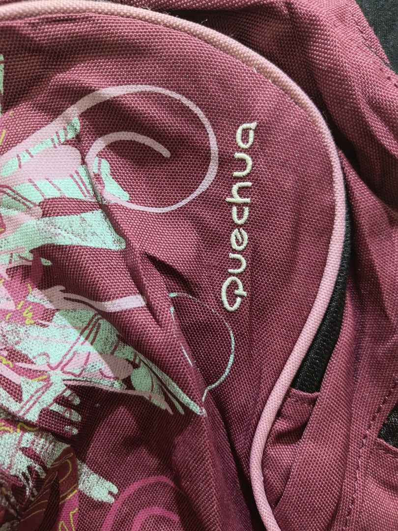 Decathlon Quechua Arpenaz 10L Backpack (Category: Backpacks) located in Quezon City. Submitted by thriftstershop (Listing ID 1415907142, Image 2). Description: Quechua Arpenaz 10L backpack is perfect for day trips. It features a main compartment, adjustable straps, and a breathable back panel. The backpack has a unique floral design on the front and a small zippered pocket. It is a compact and lightweight option for carrying essentials. Size: Wid