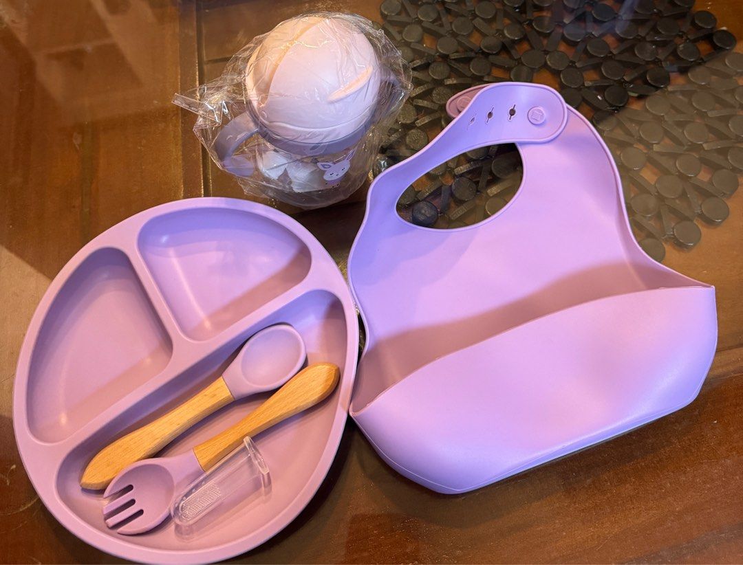 Feeding Set with Bib and Sippy Cup (Category: Weaning & Toddler Feeding) located in Quezon City. Submitted by kryshnanzyanna (Listing ID 1416008775, Image 1). Description: - Complete baby feeding set - Includes: divided plate, spoon, fork, finger toothbrush, silicone bib, and sippy cup - Soft purple color - Sippy cup features a cute bunny design - Perfect for introducing solid foods - Makes mealtimes easier.