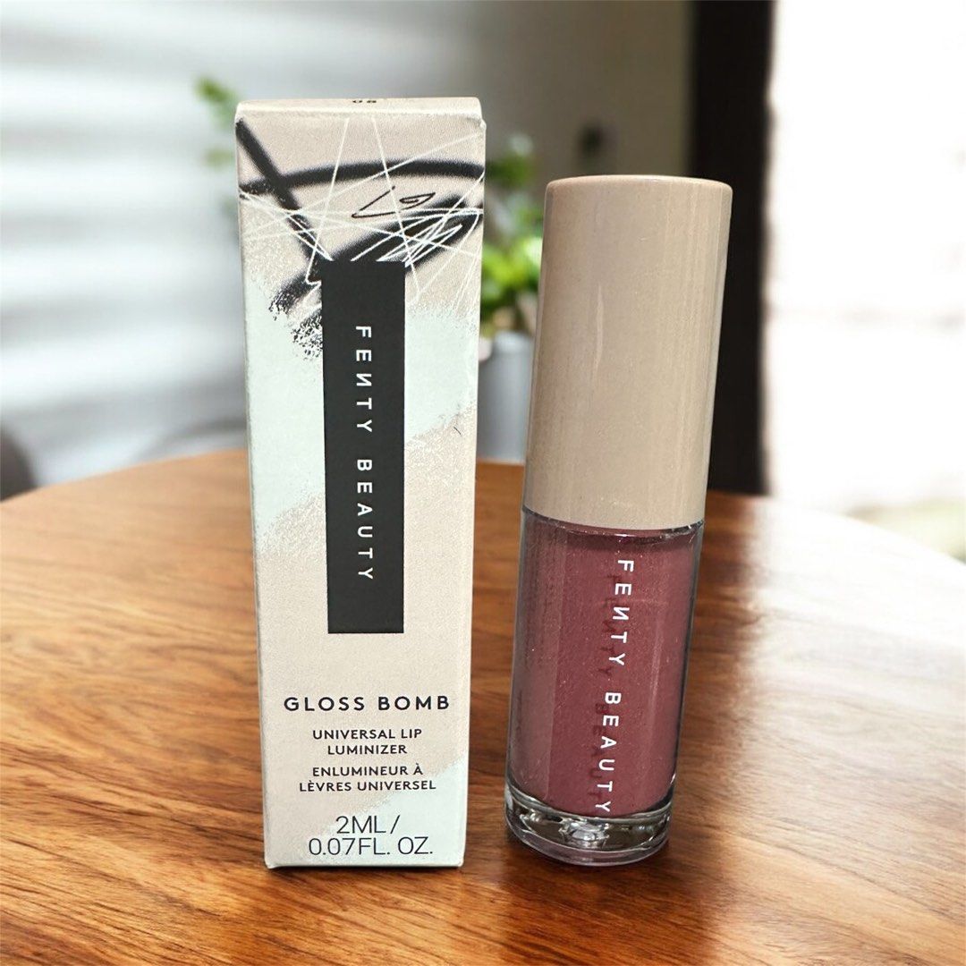 Fenty Beauty Gloss Bomb Universal Lip Luminizer (mini) (Category: Makeup) located in Paranaque City. Submitted by gramilles (Listing ID 1415848278, Image 1). Description: - Fenty Beauty Gloss Bomb Universal Lip Luminizer - Shade: 08 Riri - Size: 2ml / 0.07 fl. oz. - Provides a shiny, reddish-pink finish - Clear tube with light brown cap - Shown applied on lips.