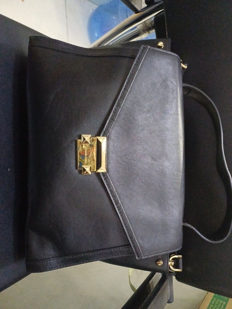 Michael Kors Black Handbag (Category: Luxury Bags & Wallets) located in Caloocan City. Submitted by rggalcar2014691 (Listing ID 1415923895, Image 2). Description: - Authentic Michael Kors handbag - Classic black leather - Elegant gold-colored clasp with studded detail - Versatile top handle and shoulder strap - Unique geometric flap design - Spacious interior for all your essentials.