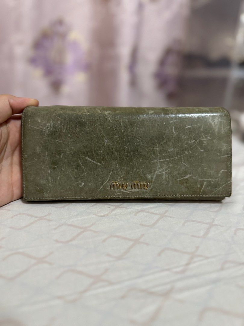 AUTHENTIC Miu Miu Long Wallet (Category: Luxury Bags & Wallets) located in Quezon City. Submitted by onestock2024 (Listing ID 1415956924, Image 1). Description: Authentic Miu Miu long wallet in a green hue. Features a snap closure and multiple card slots. The interior is a lighter shade of pink. Includes a zippered compartment for coins or other small items. 💳Mode of Payment: Gcash, BPI, and Cod 🚚Mode of Delivery: Grab (same day delivery), Lala