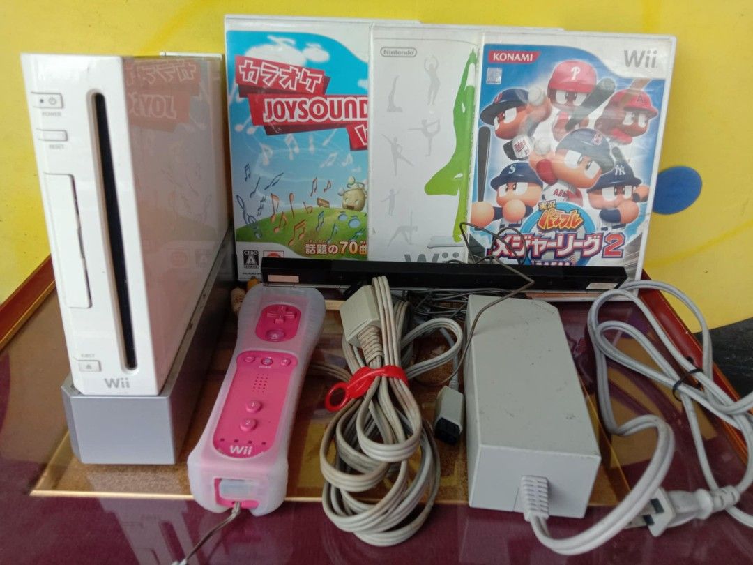 Nintendo Wii Console with Games (Category: Nintendo) located in Quezon City. Submitted by jpnvintageonline (Listing ID 1415863500, Image 2). Description: - White Nintendo Wii console - Pink remote with silicone cover - Games included: Karaoke Joysound Wii, fitness game, baseball game - Includes power adapter and sensor bar - All necessary cables are included - Ready to play!.