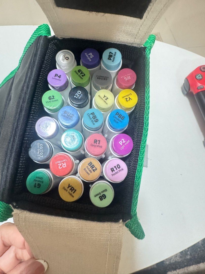 Ohuhu Marker Set with Case (Category: Stationery & School Supplies) located in Imus. Submitted by garetho1923 (Listing ID 1415957242, Image 2). Description: - Ohuhu marker set - Comes with a green and white carrying case with Ohuhu logo - Includes a variety of colored markers - Markers are labeled with color codes - Carrying case has a handle for easy transport.