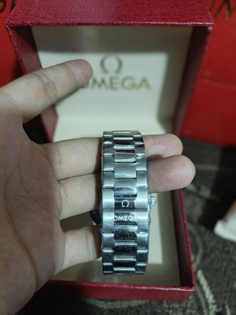 Omega Watch with Rose Gold Dial (Category: Luxury Watches) located in Meycauayan. Submitted by heronskie05 (Listing ID 1415870993, Image 3). Description: Omega watch features a rose gold dial and a stainless steel bracelet. It comes with its original box. The watch has a silver-colored case and a matching bracelet. The dial has a simple, elegant design with silver-colored hands and markers..