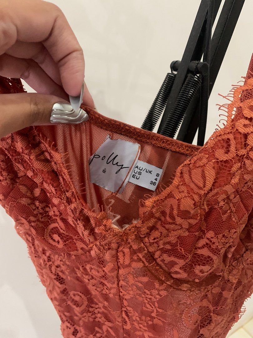 Polly Bodysuit - Size S (Category: Others Tops) located in Cebu City. Submitted by declutter_ysh (Listing ID 1415932989, Image 3). Description: - Terracotta lace bodysuit - Size: Small - Features adjustable straps - Flattering silhouette - Made of soft, comfortable material - Great for layering or wearing alone.
