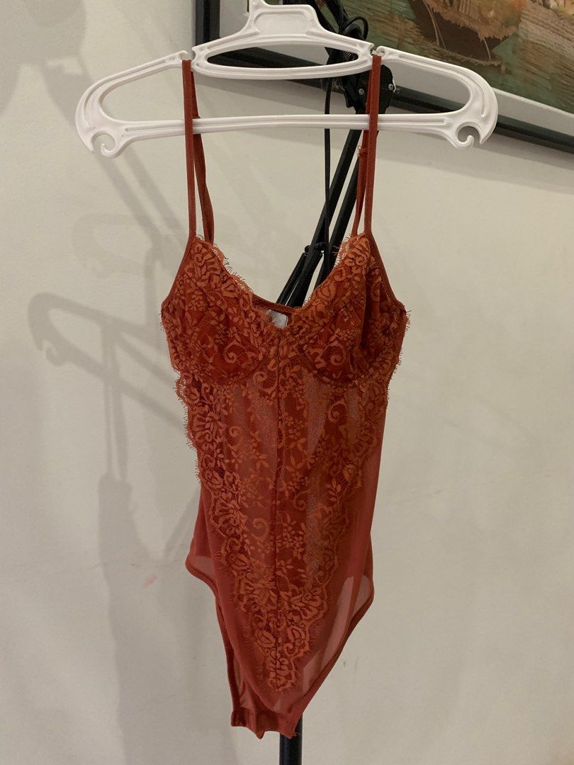 Polly Bodysuit - Size S (Category: Others Tops) located in Cebu City. Submitted by declutter_ysh (Listing ID 1415932989, Image 2). Description: - Terracotta lace bodysuit - Size: Small - Features adjustable straps - Flattering silhouette - Made of soft, comfortable material - Great for layering or wearing alone.