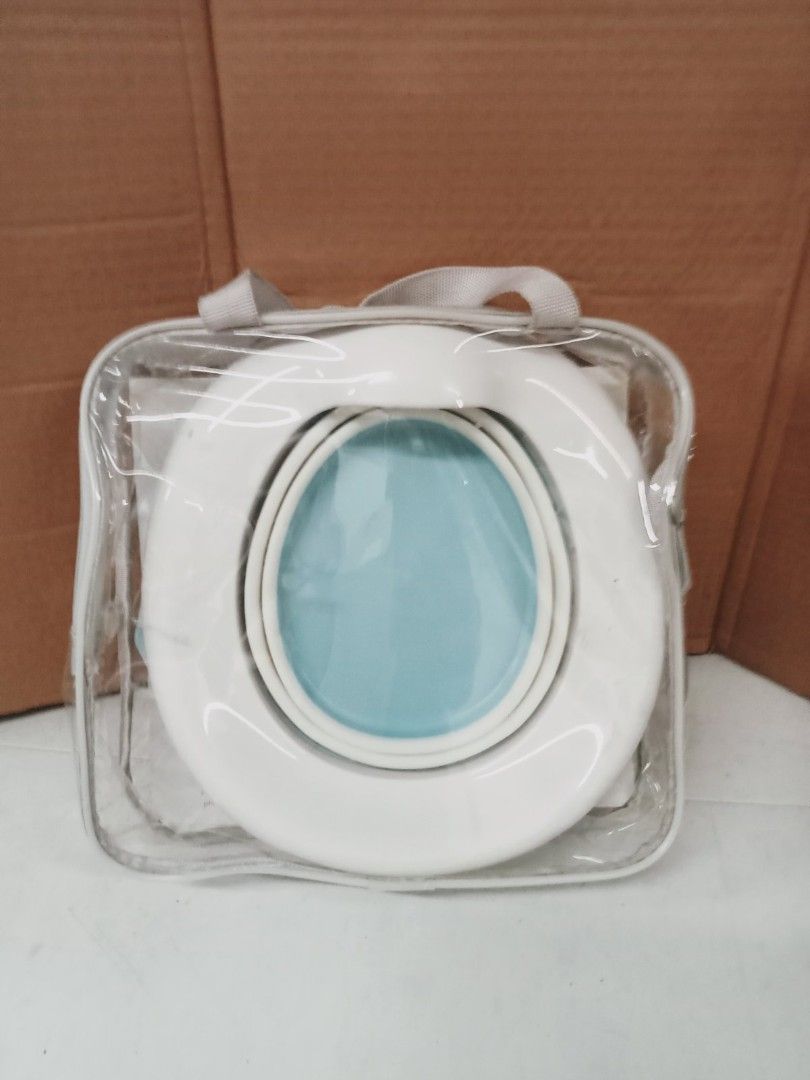 Portable Potty Training Seat (Category: Toilet Training) located in Caloocan City. Submitted by royaltiger-22e15a (Listing ID 1415933183, Image 1). Description: - Portable potty training seat for on-the-go convenience. - Includes a clear carrying case for easy transport. - Features a convenient handle. - Clean white seat with a blue interior. - Ideal for potty training at home or while traveling..