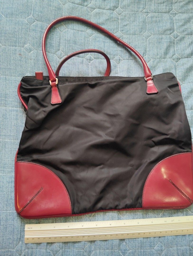 Prada Nylon Bag (Category: Luxury Bags & Wallets) located in Manila. Submitted by dcsago (Listing ID 1415873794, Image 3). Description: This is a Prada nylon tote/shoulder bag featuring the brand’s classic black nylon body combined with red leather trim and handles. The bag has a soft, slightly slouchy structure, giving it a casual yet elegant look..