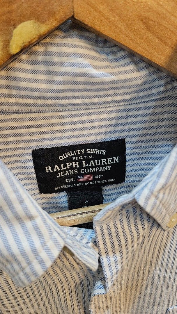Ralph Lauren Striped Shirt (Category: Tshirts & Polo Shirts ) located in Alfonso. Submitted by jbcamet (Listing ID 1415997620, Image 3). Description: - Ralph Lauren striped shirt - Light blue and white striped pattern - Button-down design - Features a chest pocket - Small logo on chest pocket - Ralph Lauren Jeans Company label.