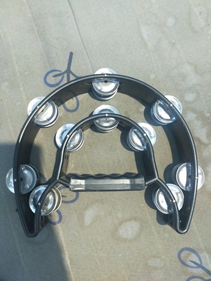 RJ Tambourine (Category: Musical Instruments) located in Manila. Submitted by alexeikaramazov (Listing ID 1415823890, Image 1). Description: - Black frame tambourine with silver jingles - Comfortable handle for easy grip - Brand logo is visible - Perfect for musicians and rhythm enthusiasts.