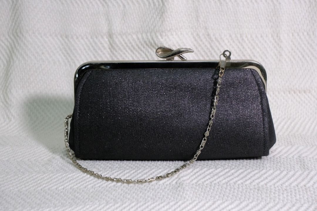 Sparkly Black Fashion Bag (Category: Clutches) located in Bacoor. Submitted by ArielJr17 (Listing ID 1415999989, Image 1). Description: - Elegant black clutch with sparkly finish - Silver-toned clasp with bow detail - Includes delicate chain strap - Spacious black interior - Fits phone, lipstick, and compact - Perfect for evening events and special occasions Meet ups on nearby areas. Open for shipping (payment first).