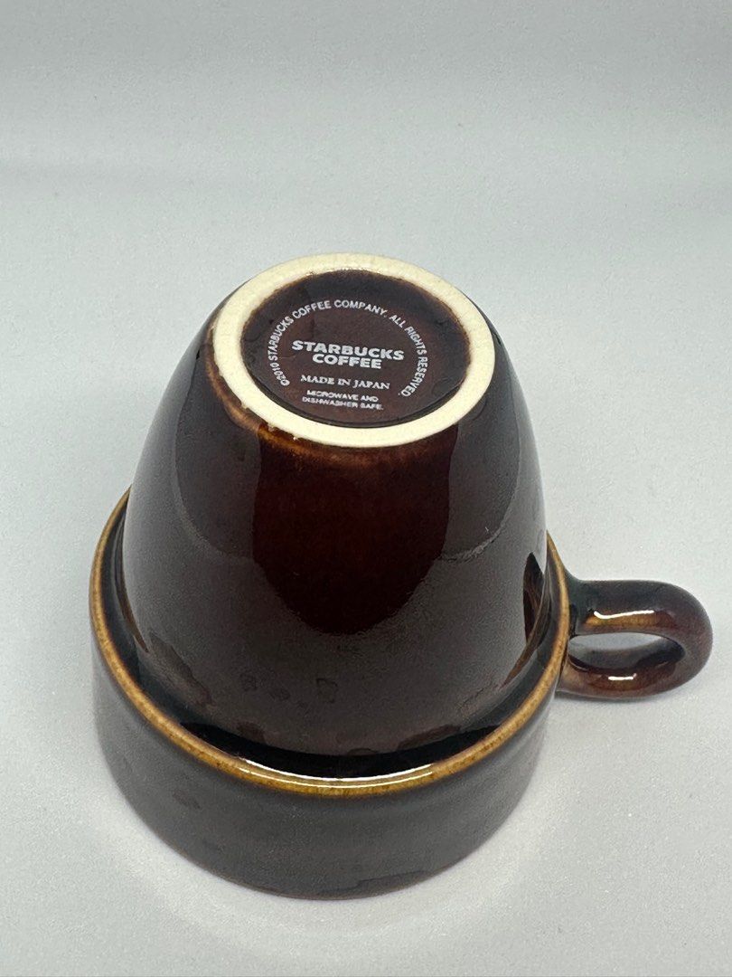 Starbucks Espresso Cup (Category: Coffee & Tea Tableware) located in Davao. Submitted by rare_finds_dvo_trd (Listing ID 1415853744, Image 2). Description: - Starbucks mug - Dark brown exterior, cream interior - Starbucks Coffee logo inside - Comfortable handle - Unique shape: wider top, narrower base.