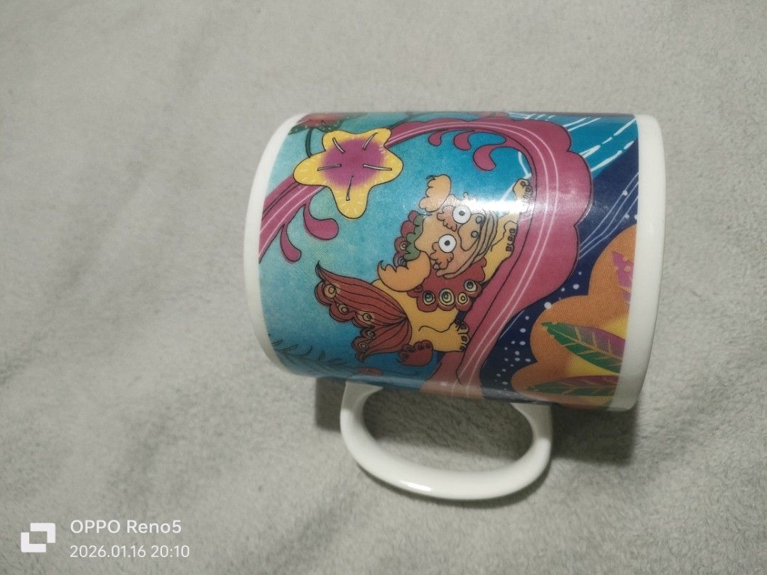 Starbucks Okinawa Mug (Category: Coffee & Tea Tableware) located in Davao. Submitted by mengsmixitems (Listing ID 1415944814, Image 2). Description: - Starbucks Okinawa mug with a unique lion-dog design. - Features a white handle and interior. - Made in Japan. - Microwave and dishwasher safe. - Starbucks logo on the bottom..