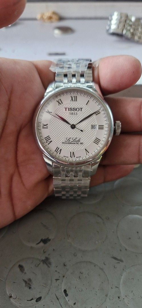 Tissot Le Locle Automatic Watch (Category: Luxury Watches) located in Tagbilaran City. Submitted by mendejohnm93739 (Listing ID 1415890925, Image 1). Description: - Tissot Le Locle Automatic Watch - White dial with Roman numeral hour markers - Stainless steel bracelet - Date display at 3 o'clock - Automatic movement (visible through the back) - Classic design, perfect for everyday wear -new original stainless bracelet.