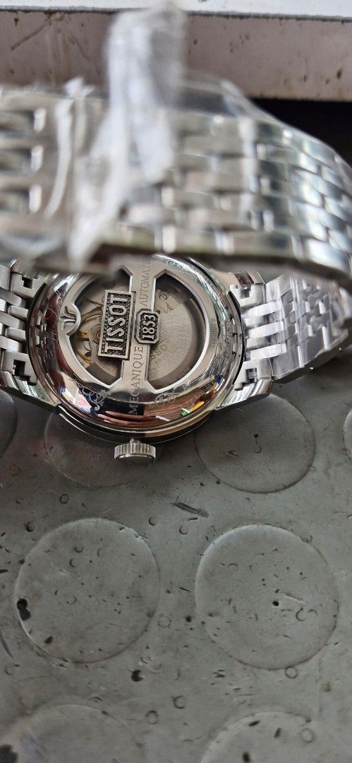 Tissot Le Locle Automatic Watch (Category: Luxury Watches) located in Tagbilaran City. Submitted by mendejohnm93739 (Listing ID 1415890925, Image 2). Description: - Tissot Le Locle Automatic Watch - White dial with Roman numeral hour markers - Stainless steel bracelet - Date display at 3 o'clock - Automatic movement (visible through the back) - Classic design, perfect for everyday wear -new original stainless bracelet.