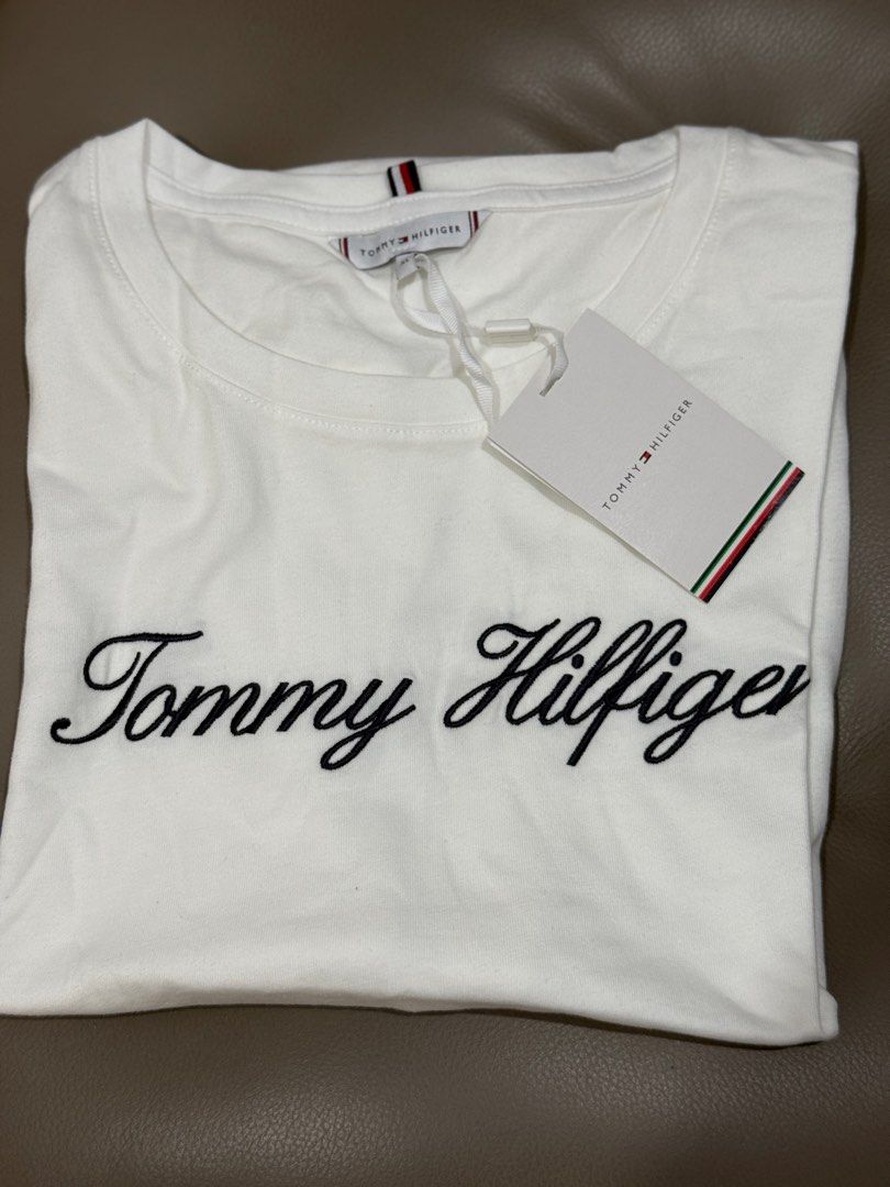 Tommy Hilfiger White Embroidered shirt (Category: Shirts) located in Pasig City. Submitted by abbyrds (Listing ID 1415893580, Image 1). Description: - Brand new Tommy Hilfiger T-shirt - Size: XL - Features an embroidered logo - Classic crew neck and short sleeves - Made with at least 95% organic cotton - Comes with original tags.