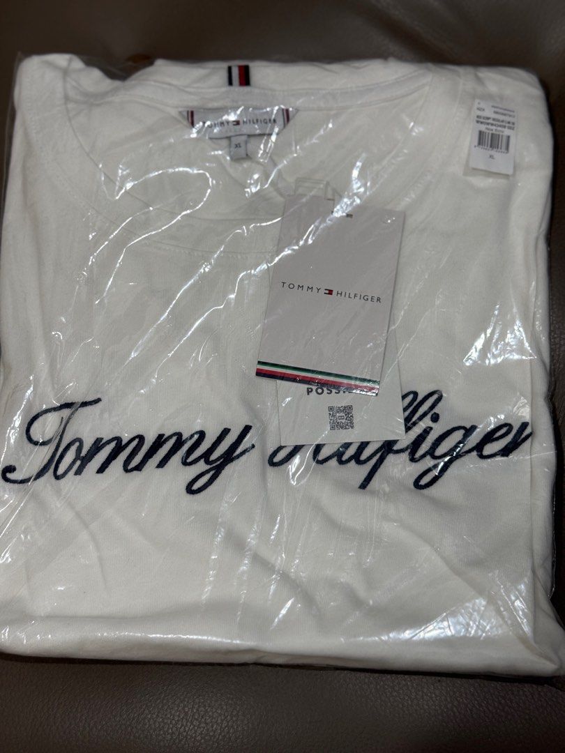 Tommy Hilfiger White Embroidered shirt (Category: Shirts) located in Pasig City. Submitted by abbyrds (Listing ID 1415893580, Image 2). Description: - Brand new Tommy Hilfiger T-shirt - Size: XL - Features an embroidered logo - Classic crew neck and short sleeves - Made with at least 95% organic cotton - Comes with original tags.