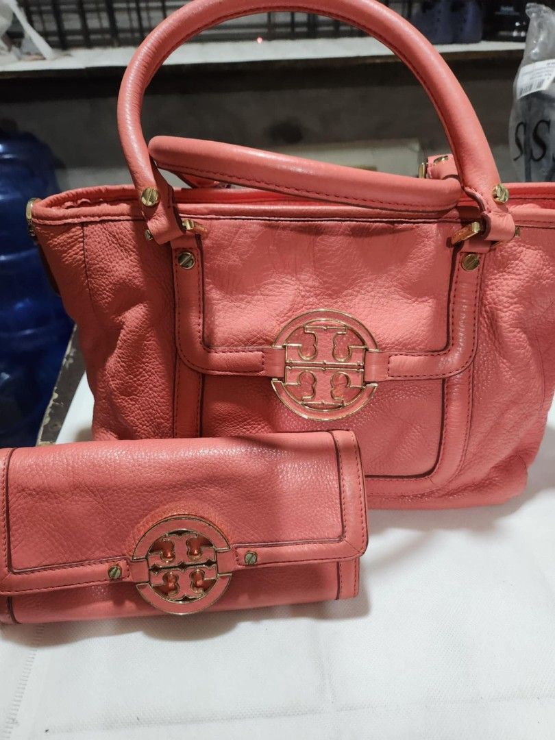Tory Burch Handbag and Wallet Set (Category: Luxury Bags & Wallets) located in Cavite. Submitted by geturs (Listing ID 1415863906, Image 2). Description: - Coral-colored Tory Burch handbag and wallet set - Handbag features top handle and front flap with Tory Burch logo - Gold-tone hardware - Matching wallet with Tory Burch logo - Includes dust bag - Made of leather.