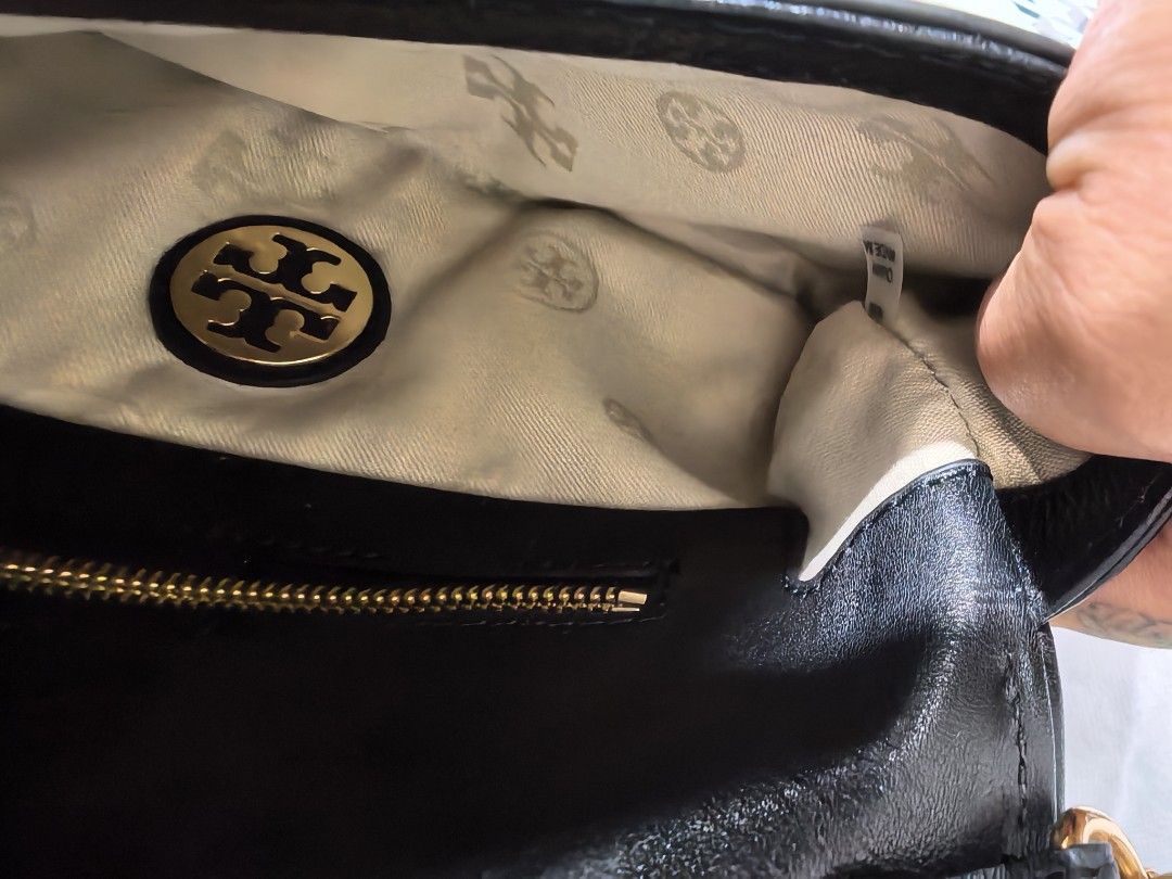 Tory Burch Reva Sling / Kili Bag (Category: Luxury Bags & Wallets) located in Santa Rosa. Submitted by djane25 (Listing ID 1416002754, Image 3). Description: - Black leather shoulder bag - Gold-tone logo and chain strap - Secure zip closure - Fabric lining with Tory Burch logo - Interior zip pocket -Minimal hairline -Payment through GCASH .