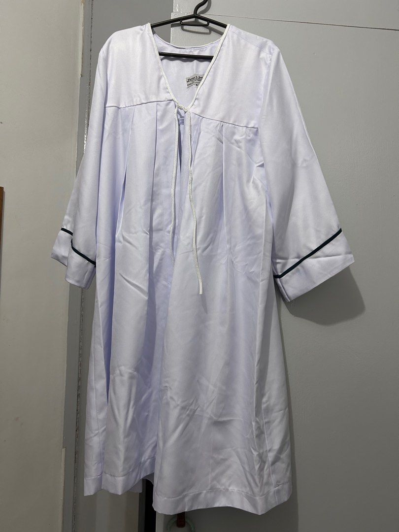 UST SHS TOGA (Category: Evening dresses & gowns) located in Marilao. Submitted by daph.clutter (Listing ID 1415971334, Image 1). Description: - White graduation gown set (size small) - Includes gown and cap - Gown features: - V-neck design - Tie closure - Black trim on sleeves - White cap with yellow string.