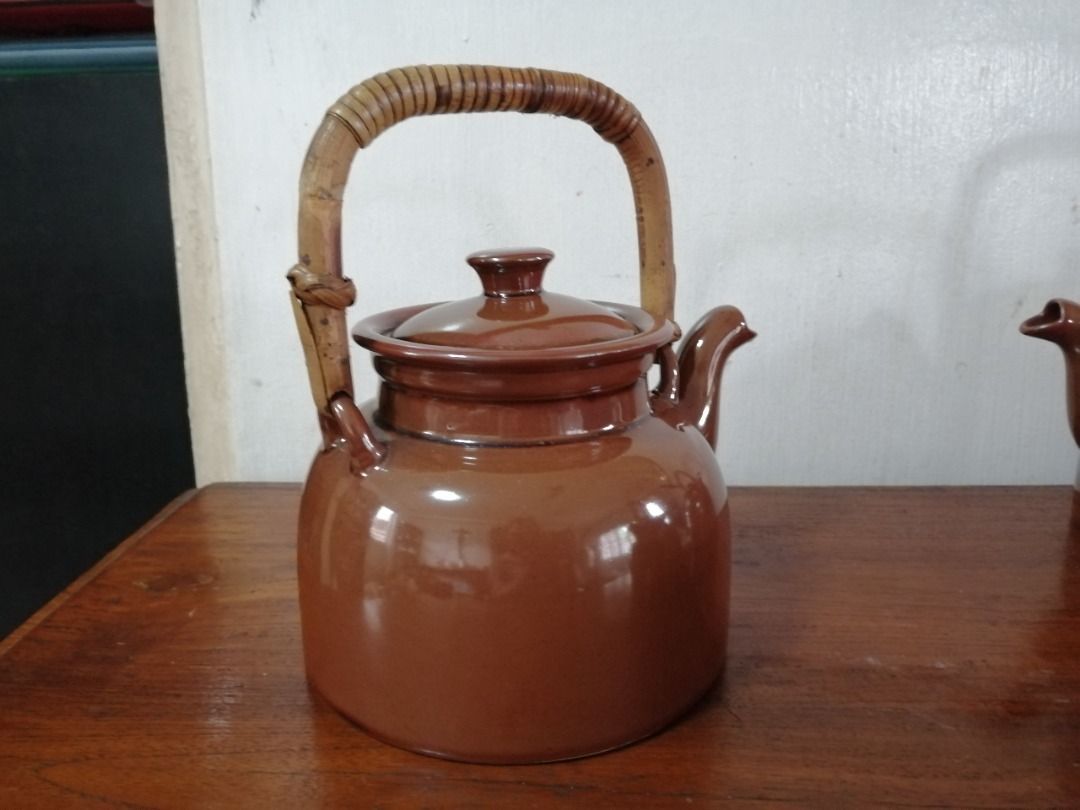 Vintage Brown Ceramic Teapot with Rattan Handle (Category: Coffee & Tea Tableware) located in Taytay. Submitted by gara1124 (Listing ID 1416006495, Image 3). Description: - Vintage brown ceramic teapot - Features a charming rattan handle - Includes a matching lid - Base diameter: approximately 6 inches Location: near Tikling, Taytay NO COD Payment upon pick up.