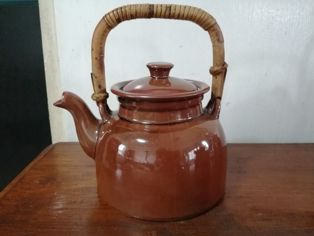 Vintage Brown Ceramic Teapot with Rattan Handle (Category: Coffee & Tea Tableware) located in Taytay. Submitted by gara1124 (Listing ID 1416006495, Image 2). Description: - Vintage brown ceramic teapot - Features a charming rattan handle - Includes a matching lid - Base diameter: approximately 6 inches Location: near Tikling, Taytay NO COD Payment upon pick up.