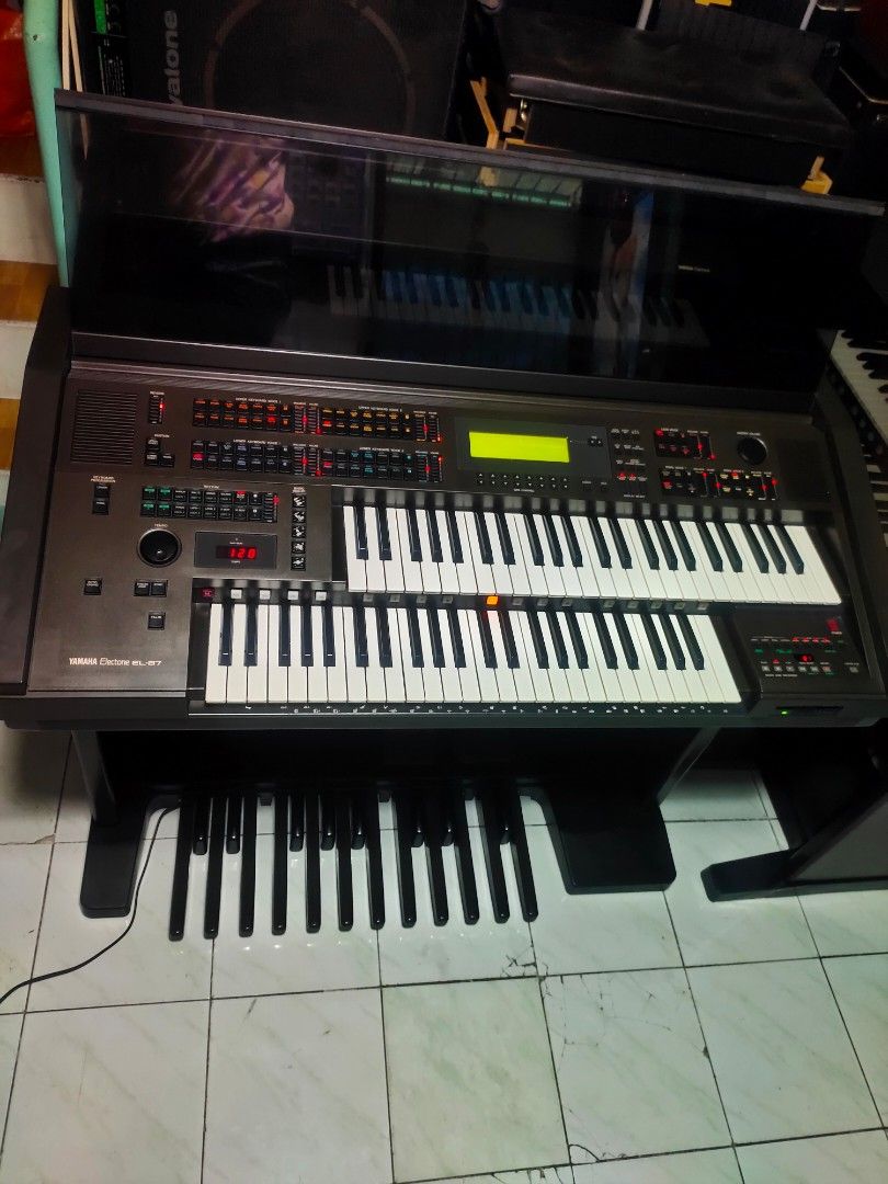 Yamaha Electone Organ (Category: Musical Instruments) located in Quezon City. Submitted by gwace1717 (Listing ID 1415838741, Image 1). Description: - Yamaha Electone EL 87 organ - Multiple keyboards - Foot pedals included - Features a control panel and display screen - Sleek black design - Professional-grade instrument.