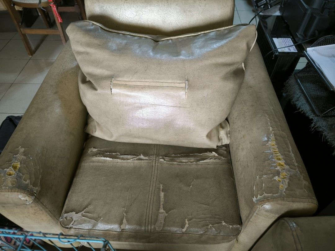 Beige Leather Sofa Set (Category: Sofas) located in Manila. Submitted by cheezu (Listing ID 1416050036, Image 2). Description: - Beige leather sofa set - Includes a three-seater sofa and two single-seater sofa - Three-seater sofa has visible wear and tear - Single-seater sofa includes a pillow.