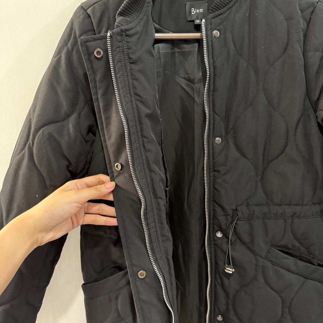 Biem Black Quilted Winter Jacket (Category: Coats, Jackets and Outerwear) located in Binan City. Submitted by ard__ (Listing ID 1416091160, Image 3). Description: - 18W 29L - padded - can send ww - Biem black quilted jacket - Size 36 - Zip and snap button closure - Two front pockets - Drawstring waist - Ribbed collar and cuffs - 100% polyester lining.