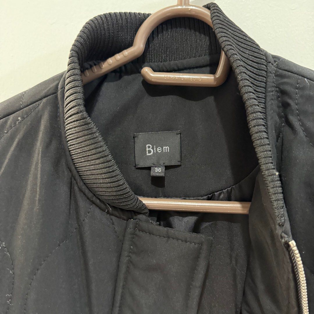 Biem Black Quilted Winter Jacket (Category: Coats, Jackets and Outerwear) located in Binan City. Submitted by ard__ (Listing ID 1416091160, Image 2). Description: - 18W 29L - padded - can send ww - Biem black quilted jacket - Size 36 - Zip and snap button closure - Two front pockets - Drawstring waist - Ribbed collar and cuffs - 100% polyester lining.