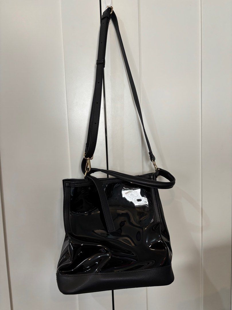 Black Patent Leather Shoulder Bag (Category: Shoulder Bags) located in Pasay City. Submitted by averycontent (Listing ID 1416038169, Image 1). Description: - Black patent leather shoulder bag - Structured design - Top handle and detachable shoulder strap - Multiple interior compartments, including a zippered pocket - Matte black base.