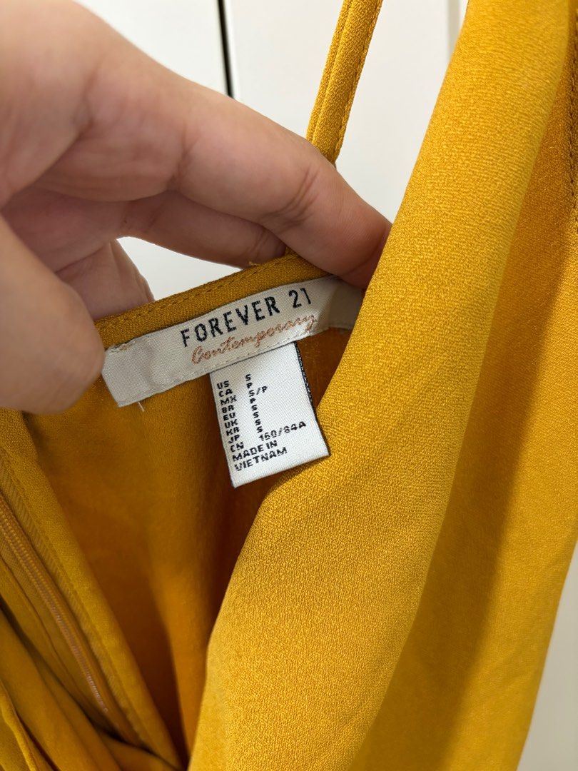 Forever 21 Mustard Midi Dress (Category: Dresses) located in Quezon City. Submitted by jamieeelaaa (Listing ID 1416177579, Image 3). Description: - Forever 21 mustard midi dress - Size: S/P - Design: Twisted knot front detail - Straps: Adjustable spaghetti straps - Neckline: V-neck - Closure: Back zipper - Origin: Made in Vietnam.